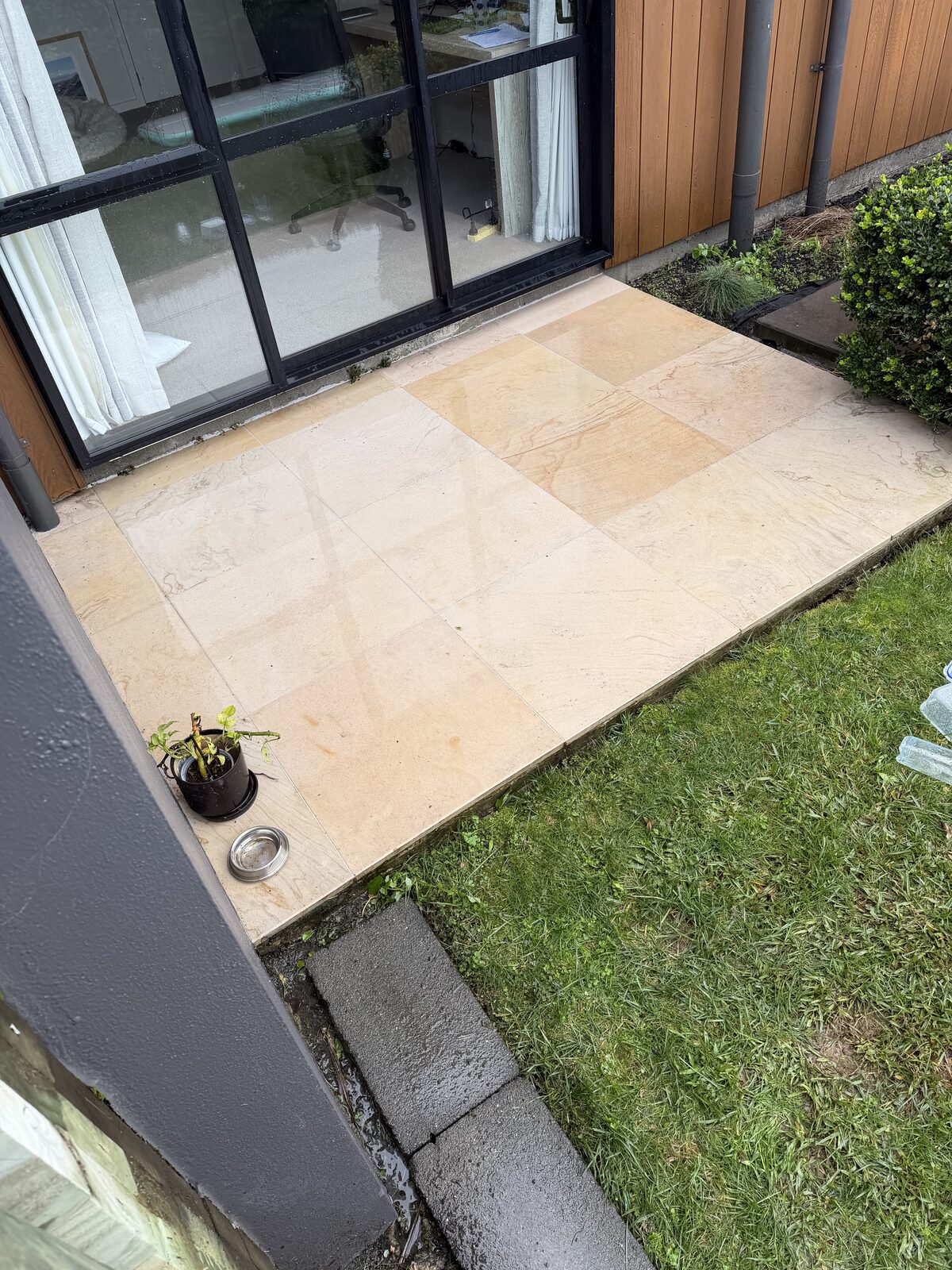 Paver patio after cleaning, restored to its natural sandstone tone